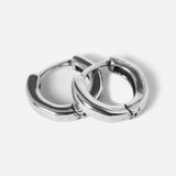 Flat lay of round earrings on white background v3