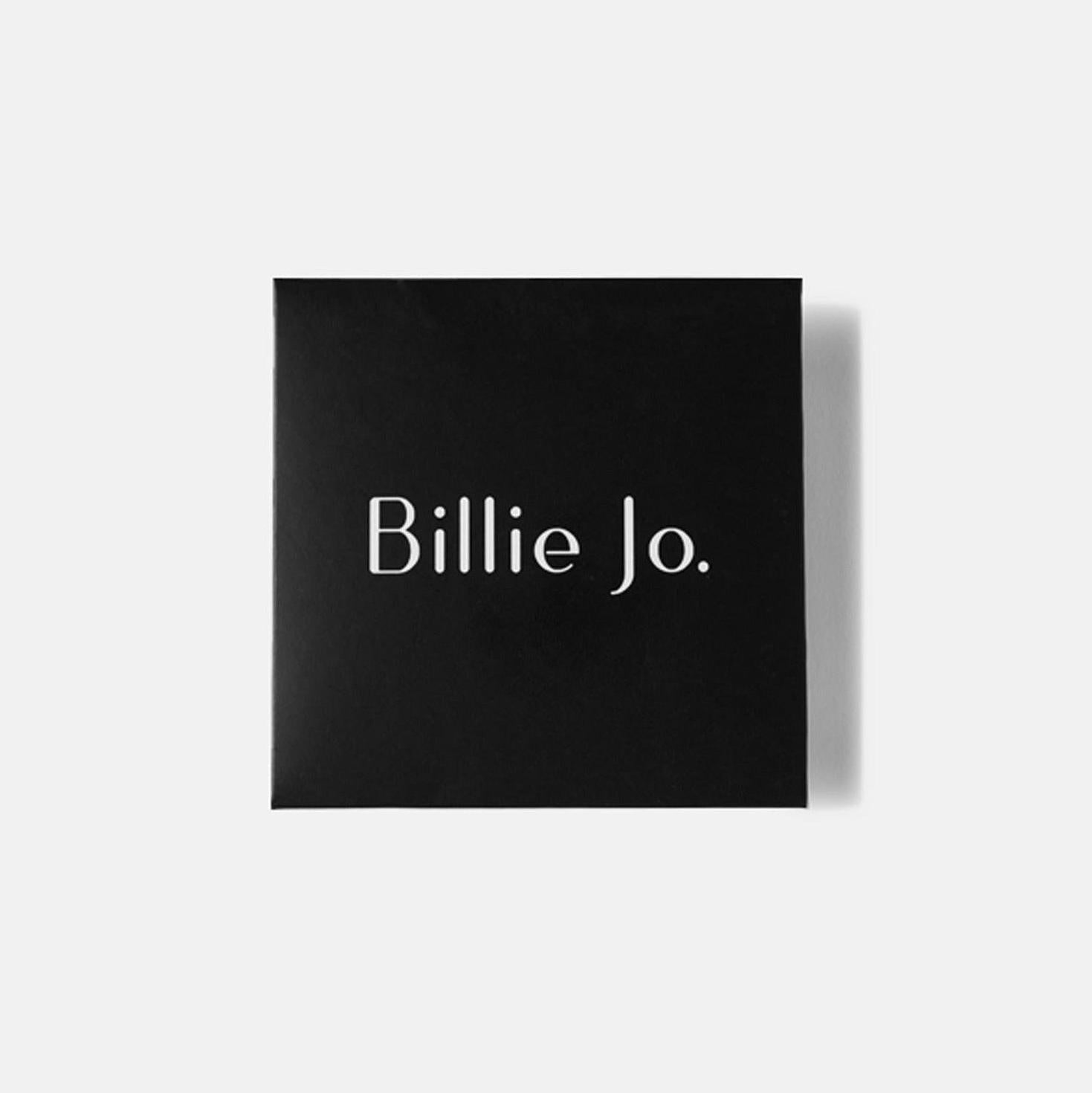 Stacked Billie Jo rings with raw textures and soft light reflections.