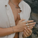 Outdoor portrait of model with layered gold jewellery and tousled hair