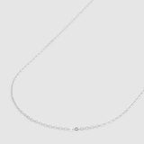 A delicate silver chain necklace displayed on a plain light gray background.